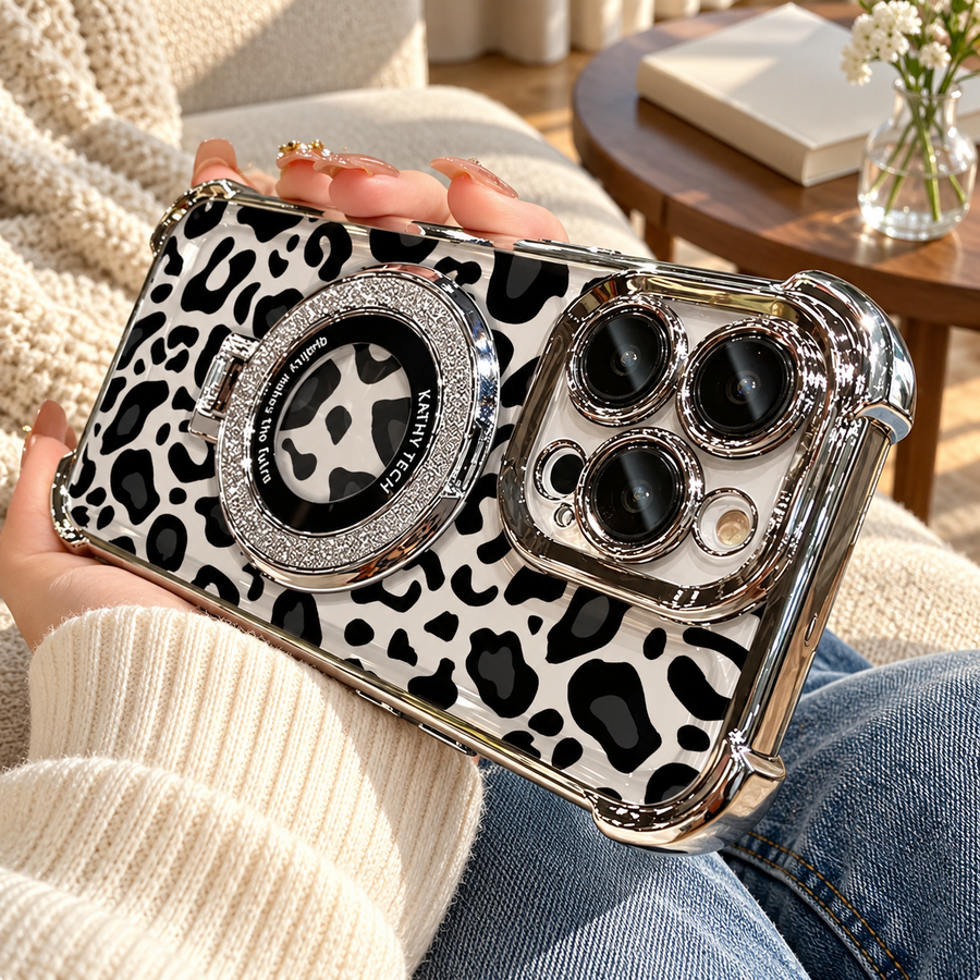 Silver leopard phone case with a glitter ring held with a cream sweater and blue jeans at home