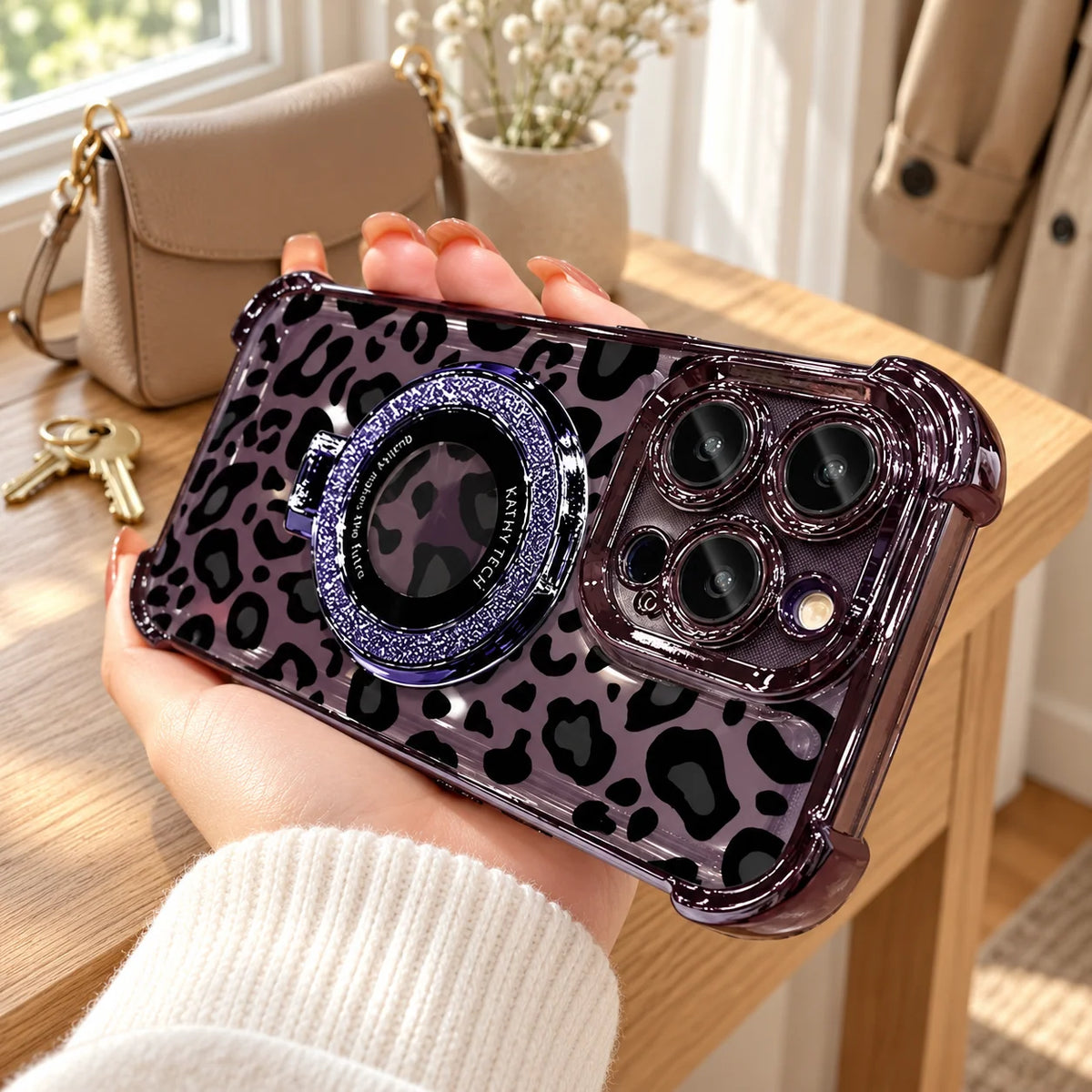Purple leopard phone case paired with a neutral handbag and cream knitwear
