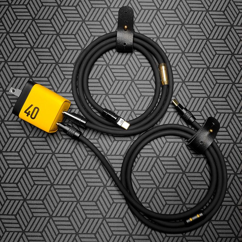 Yellow wall charger with two black USB-C charging cables and leather straps